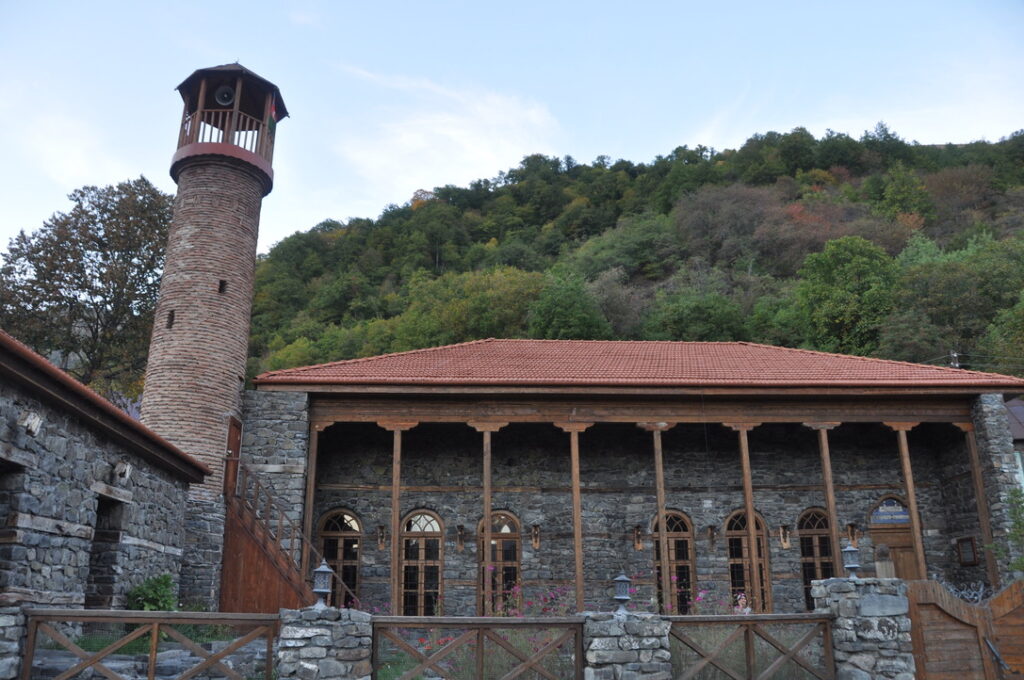Historic stone building with watchtower and red-tile roof, Azerbaijan