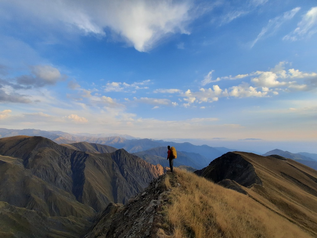 Solo hiker silhouetted on a ridge at golden hour, Azerbaijan