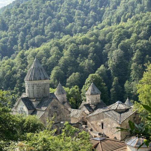 Haghartsin Monastery's stone domes surrounded by dense forested hills, Armenia