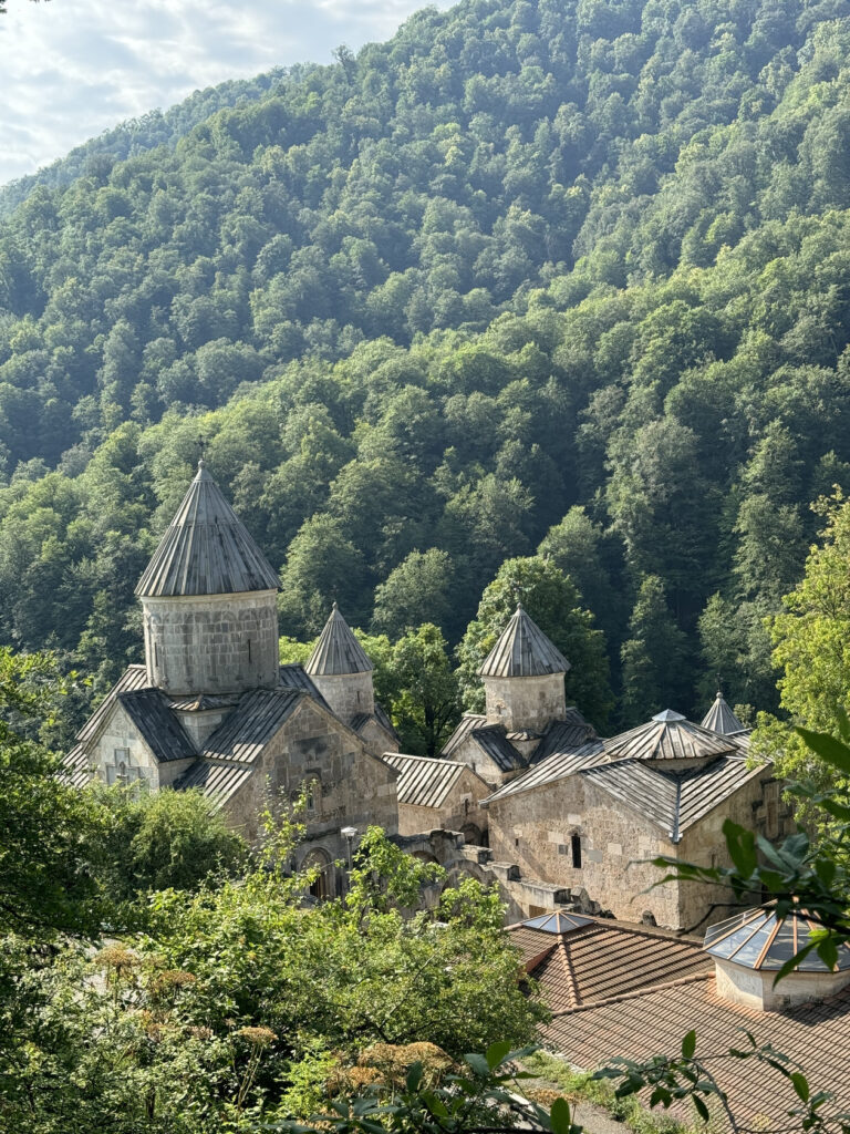 Haghartsin Monastery's stone domes surrounded by dense forested hills, Armenia