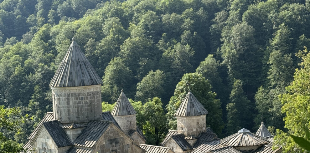 Haghartsin Monastery's stone domes surrounded by dense forested hills, Armenia