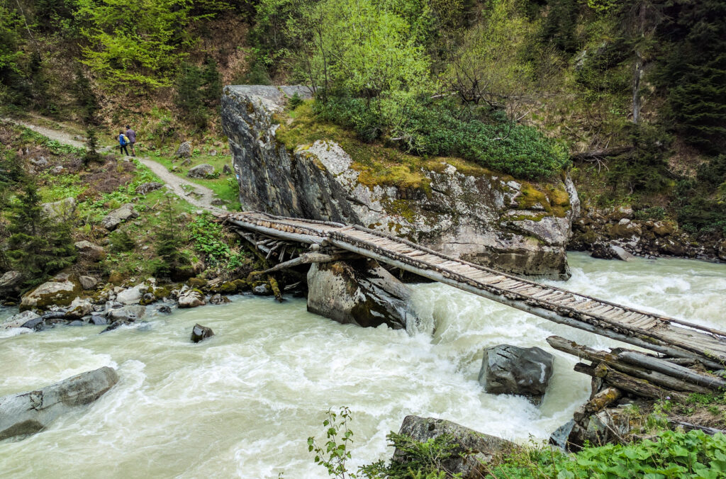 Wooden bridge over a glacial river, Svaneti, Georgia
